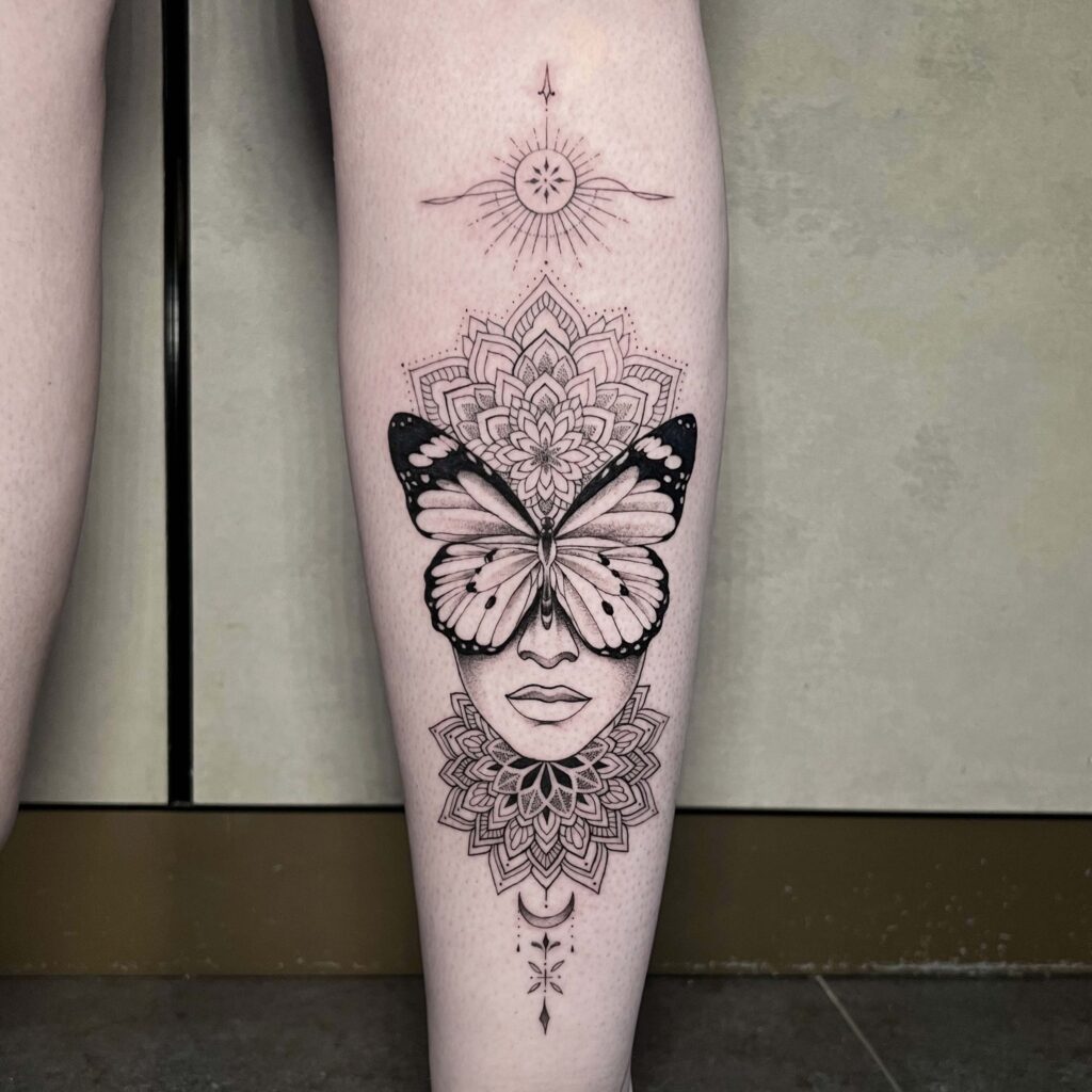 geometric butterfly face tattoo