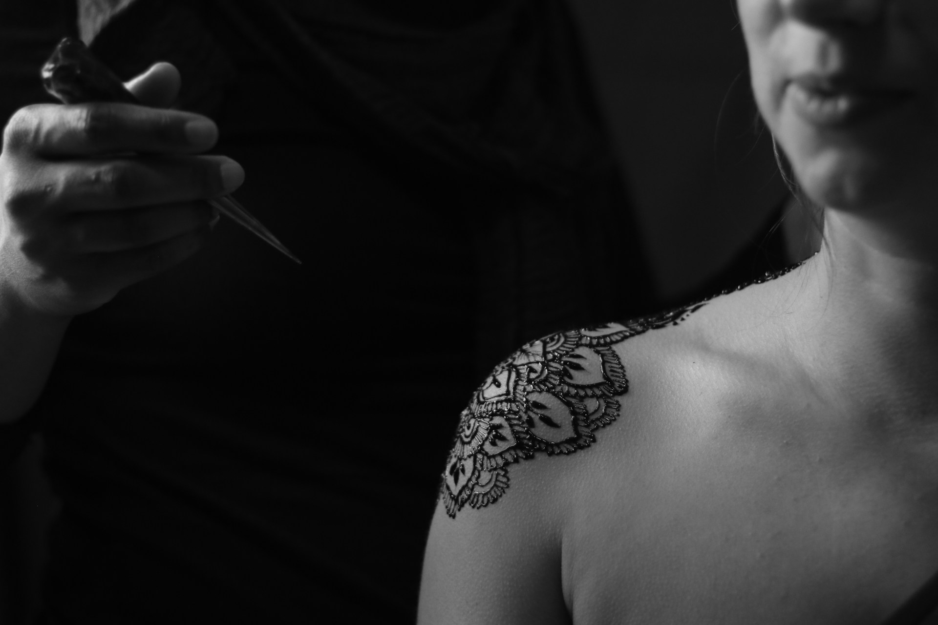 a tattoo artist working on a shoulder
